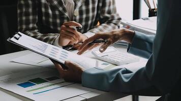 Financial analysts analyze business financial reports on a digital tablet planning investment project during a discussion at a meeting of corporate showing the results of their successful teamwork. video