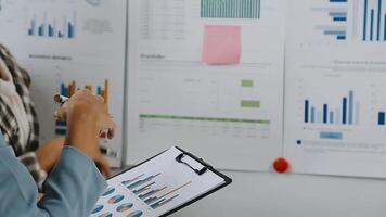 Financial analysts analyze business financial reports on a digital tablet planning investment project during a discussion at a meeting of corporate showing the results of their successful teamwork. video