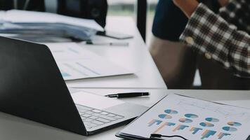 Financial analysts analyze business financial reports on a digital tablet planning investment project during a discussion at a meeting of corporate showing the results of their successful teamwork. video
