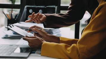 Financial analysts analyze business financial reports on a digital tablet planning investment project during a discussion at a meeting of corporate showing the results of their successful teamwork. video