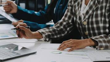 Financial analysts analyze business financial reports on a digital tablet planning investment project during a discussion at a meeting of corporate showing the results of their successful teamwork. video