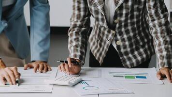 Close up Business woman using calculator and laptop for do math finance on wooden desk in office and business working background, tax, accounting, statistics and analytic research concept video