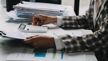 Financial analysts analyze business financial reports on a digital tablet planning investment project during a discussion at a meeting of corporate showing the results of their successful teamwork. video