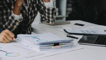 Financial analysts analyze business financial reports on a digital tablet planning investment project during a discussion at a meeting of corporate showing the results of their successful teamwork. video