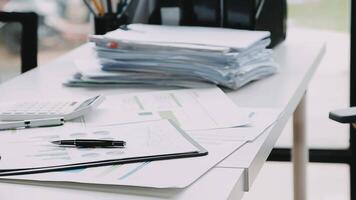 Financial analysts analyze business financial reports on a digital tablet planning investment project during a discussion at a meeting of corporate showing the results of their successful teamwork. video