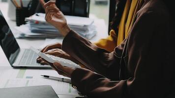 Financial analysts analyze business financial reports on a digital tablet planning investment project during a discussion at a meeting of corporate showing the results of their successful teamwork. video