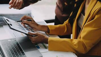 Financial analysts analyze business financial reports on a digital tablet planning investment project during a discussion at a meeting of corporate showing the results of their successful teamwork. video