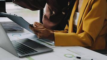 Financial analysts analyze business financial reports on a digital tablet planning investment project during a discussion at a meeting of corporate showing the results of their successful teamwork. video