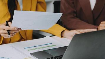 Financial analysts analyze business financial reports on a digital tablet planning investment project during a discussion at a meeting of corporate showing the results of their successful teamwork. video