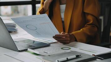 Financial analysts analyze business financial reports on a digital tablet planning investment project during a discussion at a meeting of corporate showing the results of their successful teamwork. video