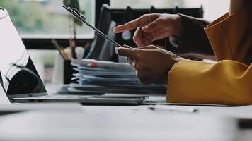 Financial analysts analyze business financial reports on a digital tablet planning investment project during a discussion at a meeting of corporate showing the results of their successful teamwork. video