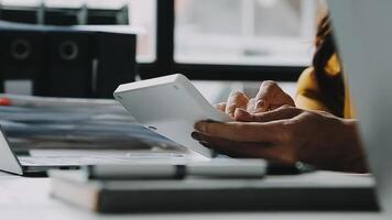Financial analysts analyze business financial reports on a digital tablet planning investment project during a discussion at a meeting of corporate showing the results of their successful teamwork. video