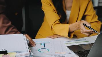 Financial analysts analyze business financial reports on a digital tablet planning investment project during a discussion at a meeting of corporate showing the results of their successful teamwork. video