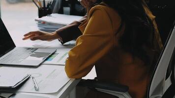 Financial analysts analyze business financial reports on a digital tablet planning investment project during a discussion at a meeting of corporate showing the results of their successful teamwork. video