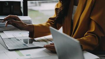 Financial analysts analyze business financial reports on a digital tablet planning investment project during a discussion at a meeting of corporate showing the results of their successful teamwork. video