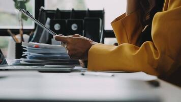 Financial analysts analyze business financial reports on a digital tablet planning investment project during a discussion at a meeting of corporate showing the results of their successful teamwork. video