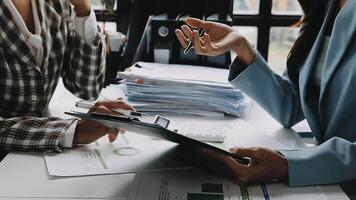 Financial analysts analyze business financial reports on a digital tablet planning investment project during a discussion at a meeting of corporate showing the results of their successful teamwork. video