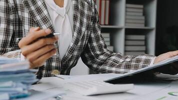 Financial analysts analyze business financial reports on a digital tablet planning investment project during a discussion at a meeting of corporate showing the results of their successful teamwork. video