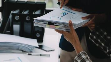 Financial analysts analyze business financial reports on a digital tablet planning investment project during a discussion at a meeting of corporate showing the results of their successful teamwork. video