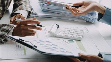 Financial analysts analyze business financial reports on a digital tablet planning investment project during a discussion at a meeting of corporate showing the results of their successful teamwork. video