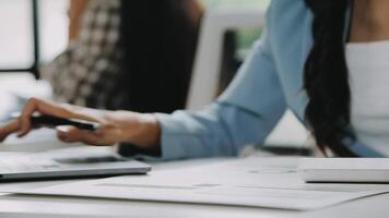 Close up Business woman using calculator and laptop for do math finance on wooden desk in office and business working background, tax, accounting, statistics and analytic research concept video