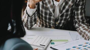Financial analysts analyze business financial reports on a digital tablet planning investment project during a discussion at a meeting of corporate showing the results of their successful teamwork. video