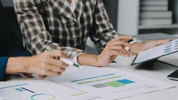 Financial analysts analyze business financial reports on a digital tablet planning investment project during a discussion at a meeting of corporate showing the results of their successful teamwork. video