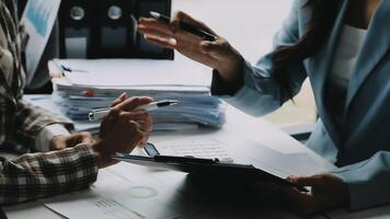 Financial analysts analyze business financial reports on a digital tablet planning investment project during a discussion at a meeting of corporate showing the results of their successful teamwork. video