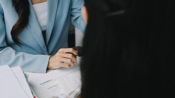 Financial analysts analyze business financial reports on a digital tablet planning investment project during a discussion at a meeting of corporate showing the results of their successful teamwork. video