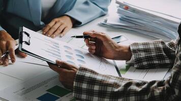 Financial analysts analyze business financial reports on a digital tablet planning investment project during a discussion at a meeting of corporate showing the results of their successful teamwork. video