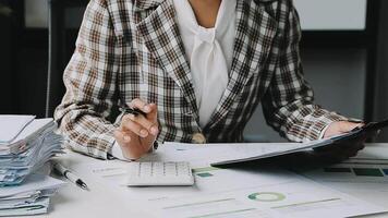 Financial analysts analyze business financial reports on a digital tablet planning investment project during a discussion at a meeting of corporate showing the results of their successful teamwork. video