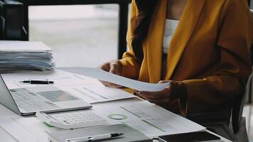 Financial analysts analyze business financial reports on a digital tablet planning investment project during a discussion at a meeting of corporate showing the results of their successful teamwork. video