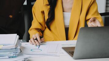 Financial analysts analyze business financial reports on a digital tablet planning investment project during a discussion at a meeting of corporate showing the results of their successful teamwork. video