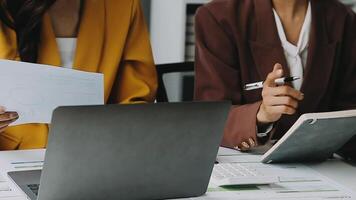 Financial analysts analyze business financial reports on a digital tablet planning investment project during a discussion at a meeting of corporate showing the results of their successful teamwork. video