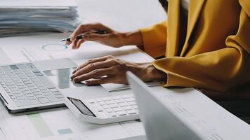 Financial analysts analyze business financial reports on a digital tablet planning investment project during a discussion at a meeting of corporate showing the results of their successful teamwork. video