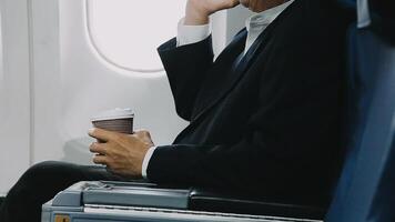 Traveling and technology. young business woman working on smartphone and Laptop computer, Tablet while sitting in airplane. video