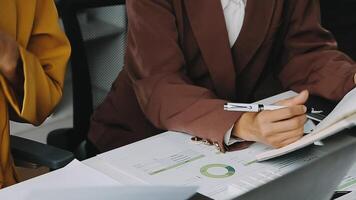 Financial analysts analyze business financial reports on a digital tablet planning investment project during a discussion at a meeting of corporate showing the results of their successful teamwork. video