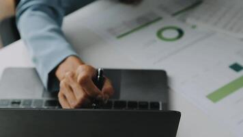 Financial analysts analyze business financial reports on a digital tablet planning investment project during a discussion at a meeting of corporate showing the results of their successful teamwork. video