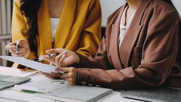 Financial analysts analyze business financial reports on a digital tablet planning investment project during a discussion at a meeting of corporate showing the results of their successful teamwork. video