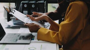 Financial analysts analyze business financial reports on a digital tablet planning investment project during a discussion at a meeting of corporate showing the results of their successful teamwork. video