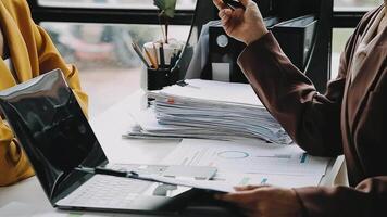 Financial analysts analyze business financial reports on a digital tablet planning investment project during a discussion at a meeting of corporate showing the results of their successful teamwork. video