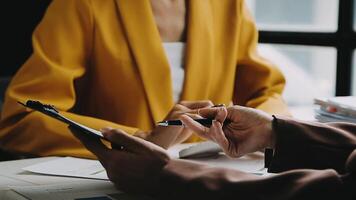 Financial analysts analyze business financial reports on a digital tablet planning investment project during a discussion at a meeting of corporate showing the results of their successful teamwork. video