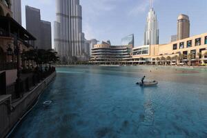 uae, dubai , 1th December 2022 a picture of the burj khalifa with towers and buildings in the night with small lake photo