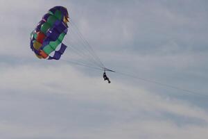 skydiving in the sky in cloudy sky photo
