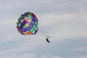 skydiving in the sky in blue sky photo