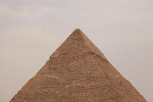 the pyramids of egypt , the pyramid of khufu is the largest pyramid in giza governorate photo