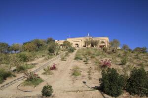 Saddam palace on hill in Babylon with blue sky photo
