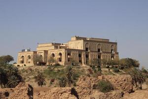 Saddam palace on hill in Babylon with blue sky photo