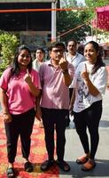 New Delhi, India - May 25 2024 - Unidentified people showing their ink-marked fingers after casting votes in front of polling booth of east Delhi area for general Lok Sabha Elections 2024 photo