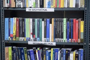 New Delhi, India, February 17 2024 - Variety of Books on shelf inside a book-stall at Delhi International Book Fair, Selection of books on display in Annual Book Fair at Bharat Mandapam complex photo